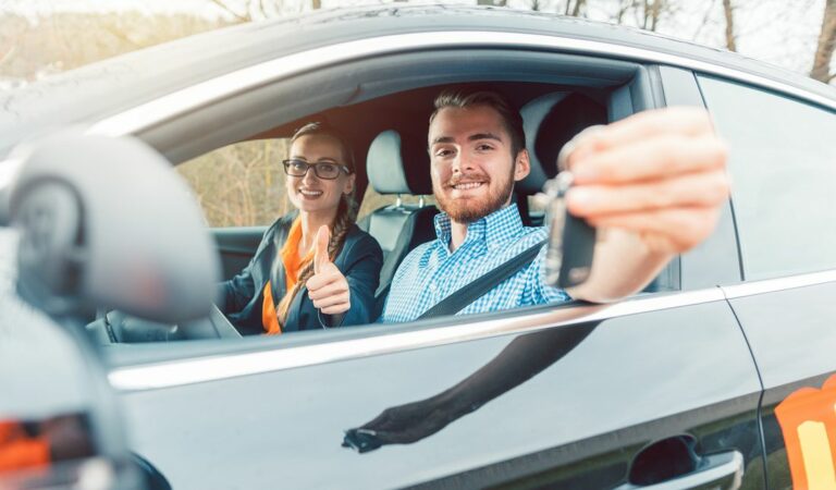 student-of-driving-school-having-passed-his-final-test-showing-the-car-keys