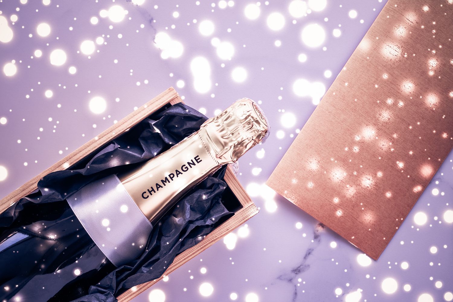 champagne-bottle-and-gift-box-on-purple-holiday-glitter-new-years-christmas-valentines-day-winter-present-and-luxury-product-packaging-for-beverage-brand