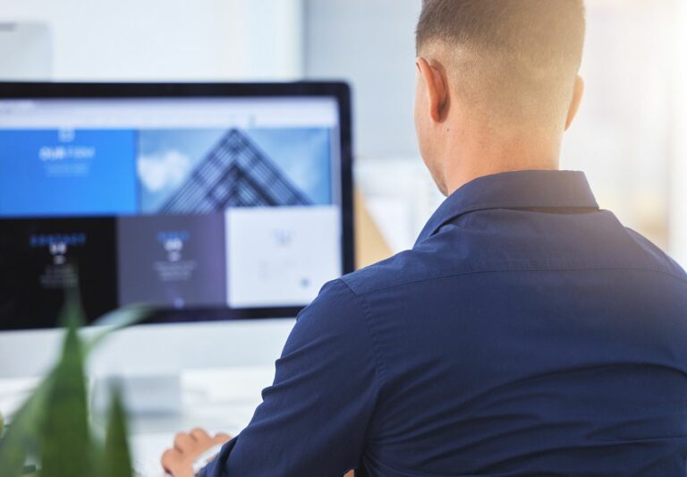 want-to-create-your-own-website-we-can-help-with-that-rearview-shot-of-a-designer-working-on-his-computer