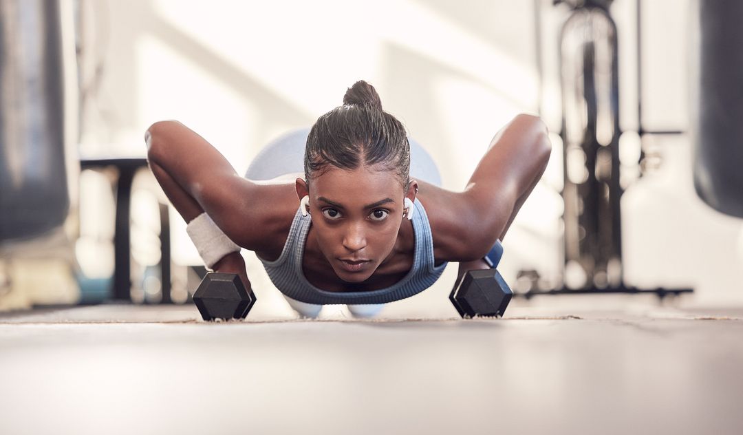 dumbbell-fitness-and-woman-training-body-goals-muscle-and-wellness-motivation-strong-power-and-sports-girl-doing-push-up-exercise-with-gear