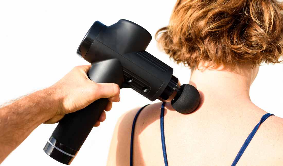 handheld personal massager on neck and shoulders