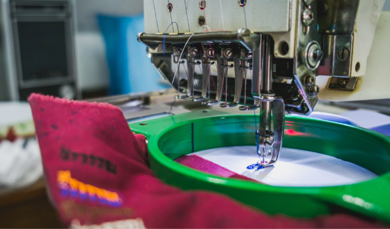 Embroidery machine with a blank canvas and thread