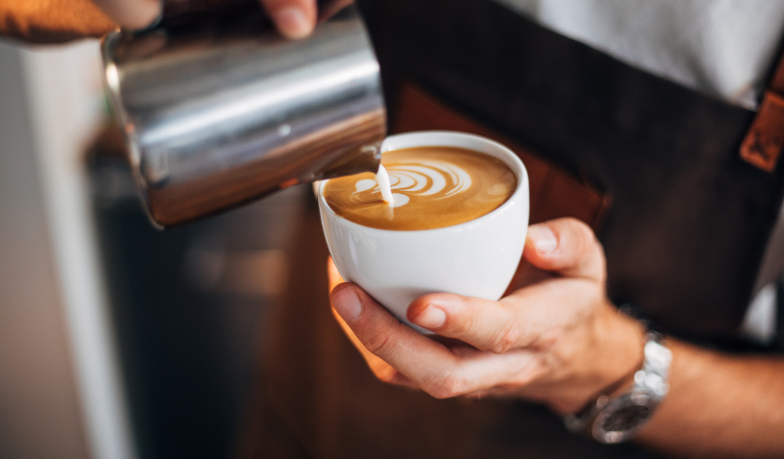 barista holding a cup of espresso