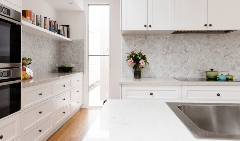 beautiful kitchen with granite counters and a marble backsplash