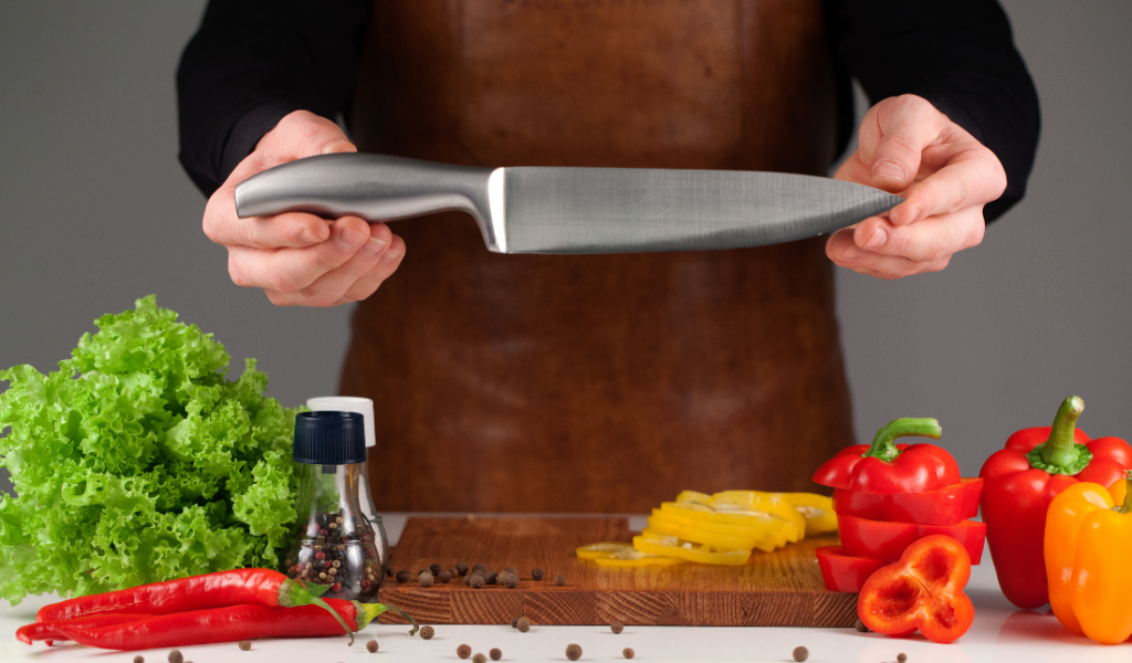 chef's hand holding a knife