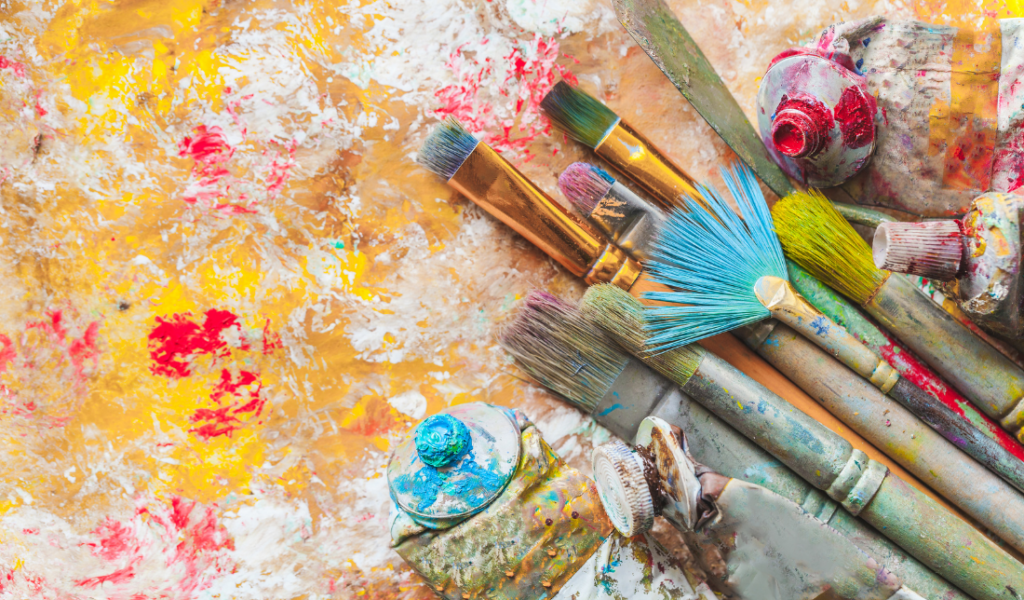 colorful paint palette with various paint brushes