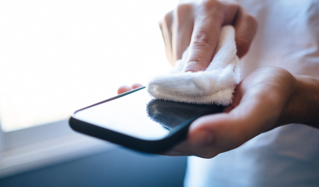 device being cleaned with a microfiber cloth