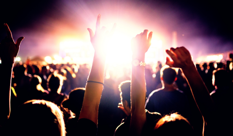 group of Millennials dancing at a music festival