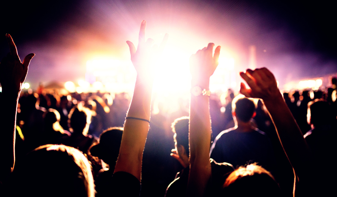 group of Millennials dancing at a music festival