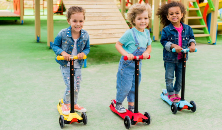 group of children riding on kick scooters