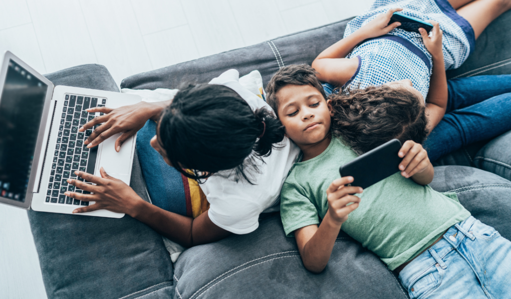 group of diverse Armed Forces families engaging with a digital device