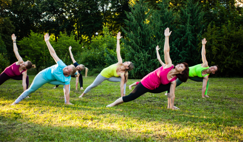 group of women exercising together outdoors