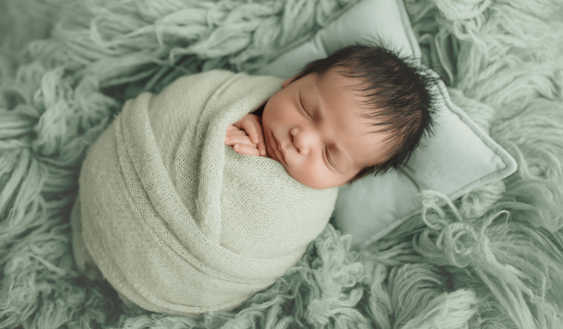happy baby wrapped in a soft, organic blanket