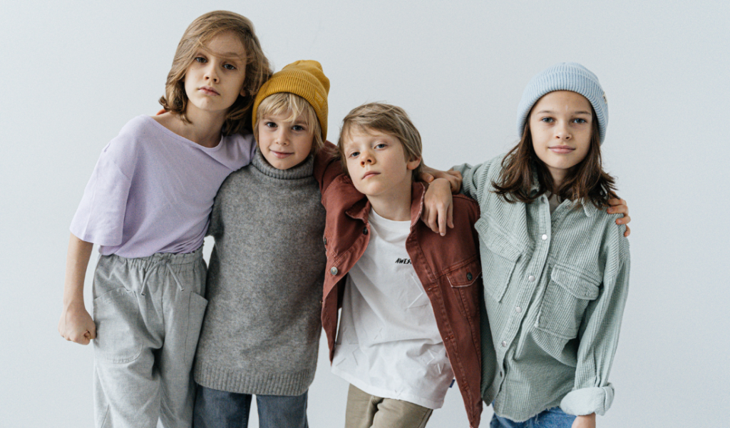 happy children holding hands while wearing stylish and trendy clothes