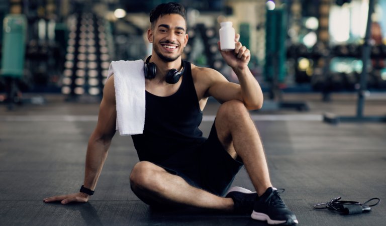 health-conscious individual exercising or holding supplement capsules