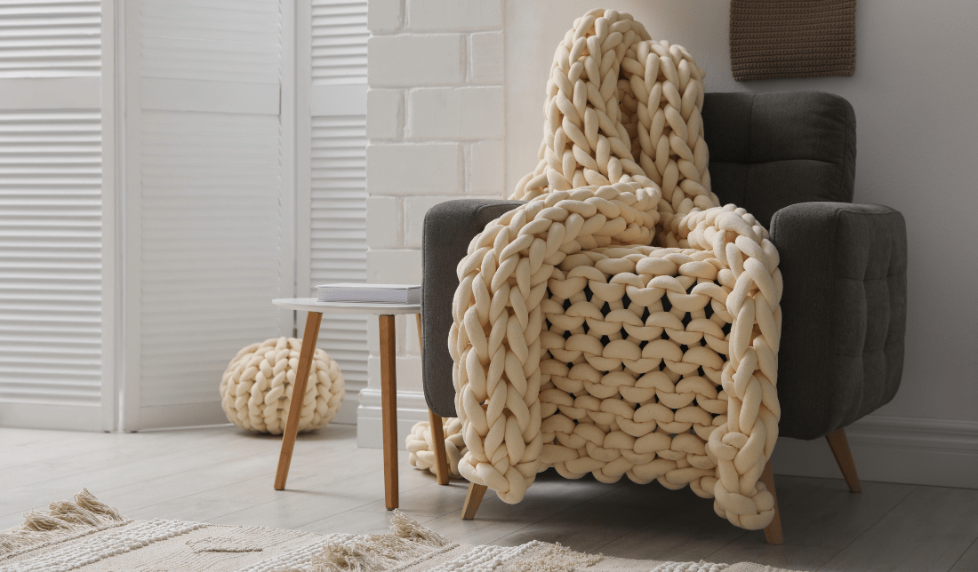 living room with a chunky knit throw blanket