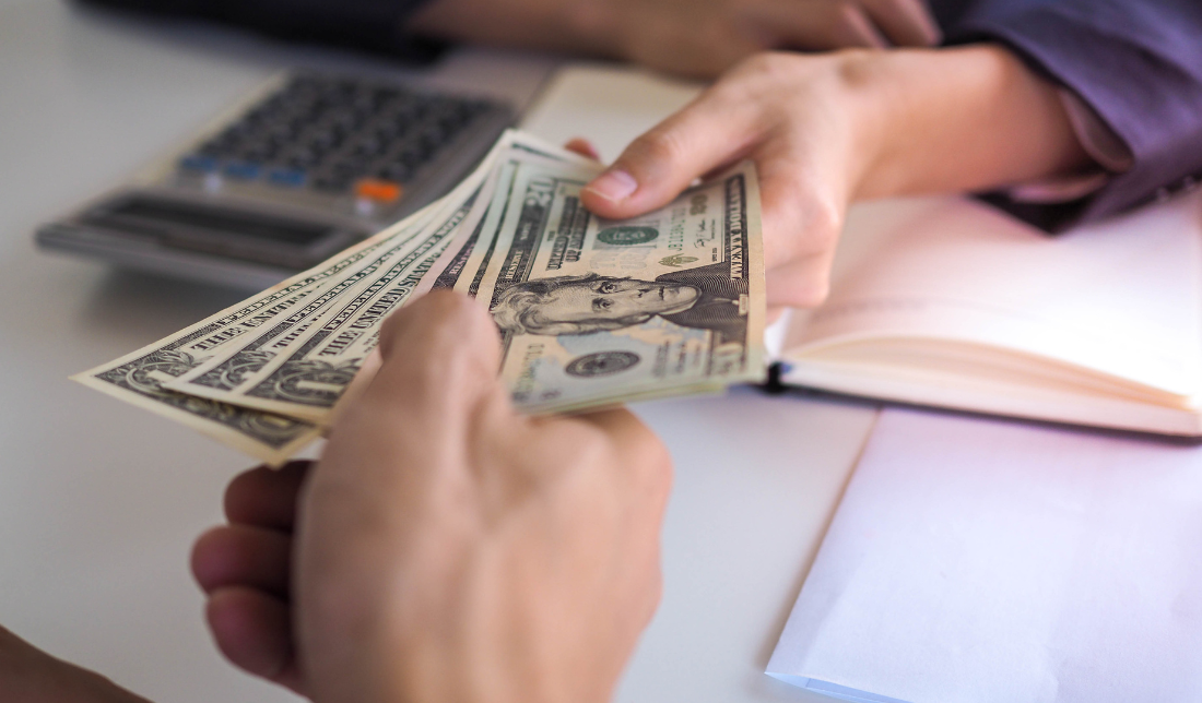 person handing over money to another, signifying investors delivering pledges