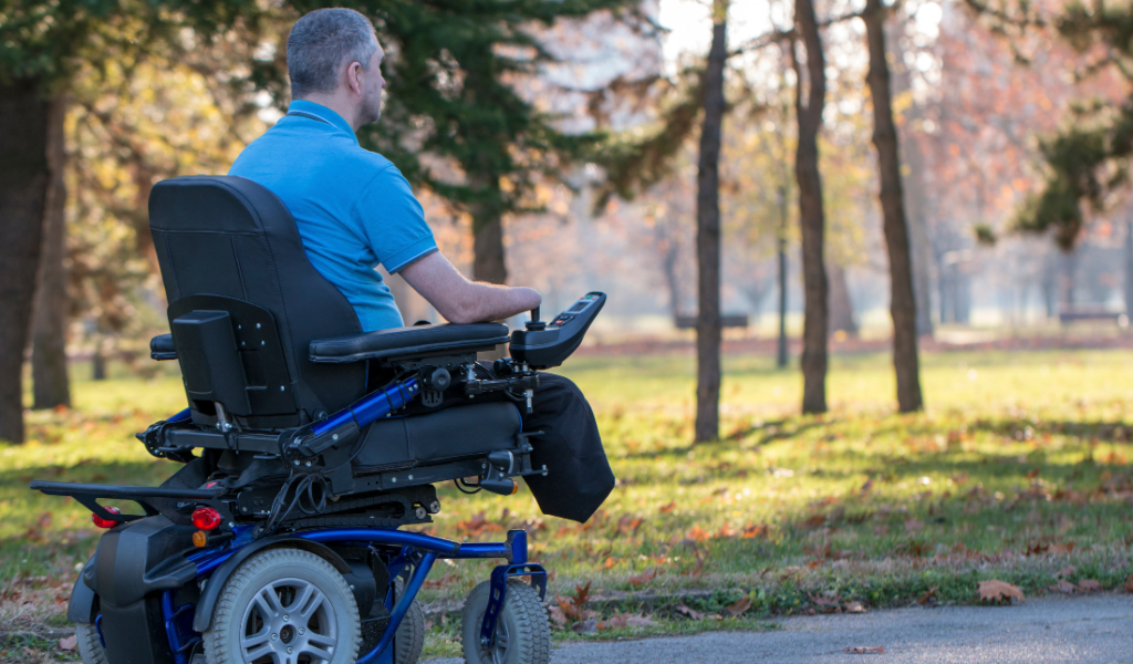 person with mobility issues sitting in an electric wheelchair