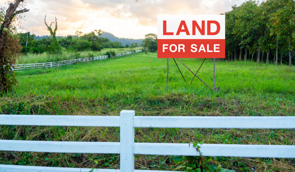 plot of residential land with a 'For Sale' sign