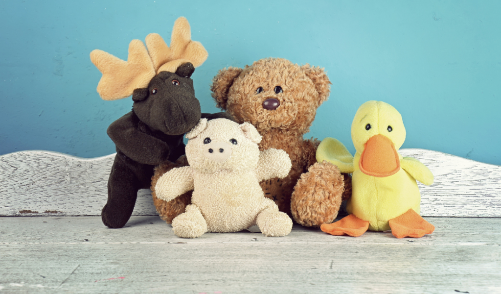plush sloth with a mug of hot chocolate in its hand