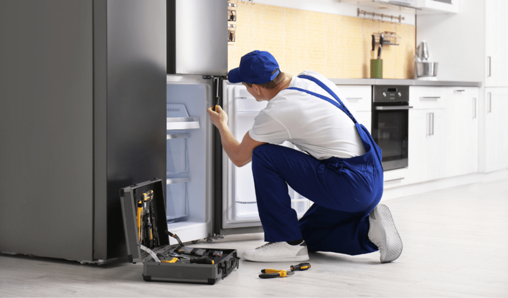 repair technician fixing an appliance