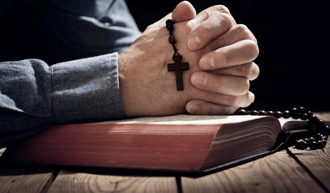 rosary, a cross, a Bible