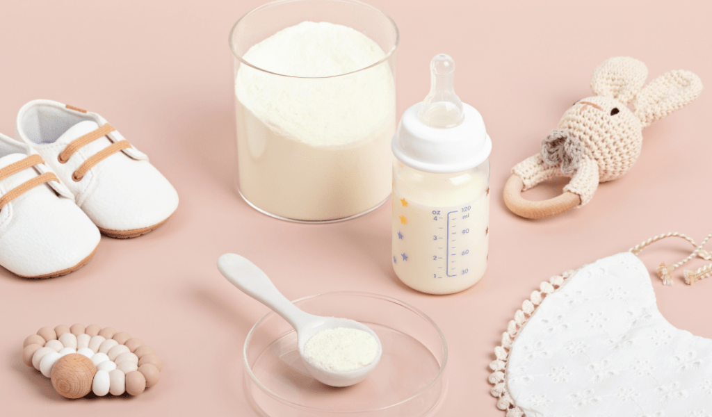 smiling baby being fed organic baby formula