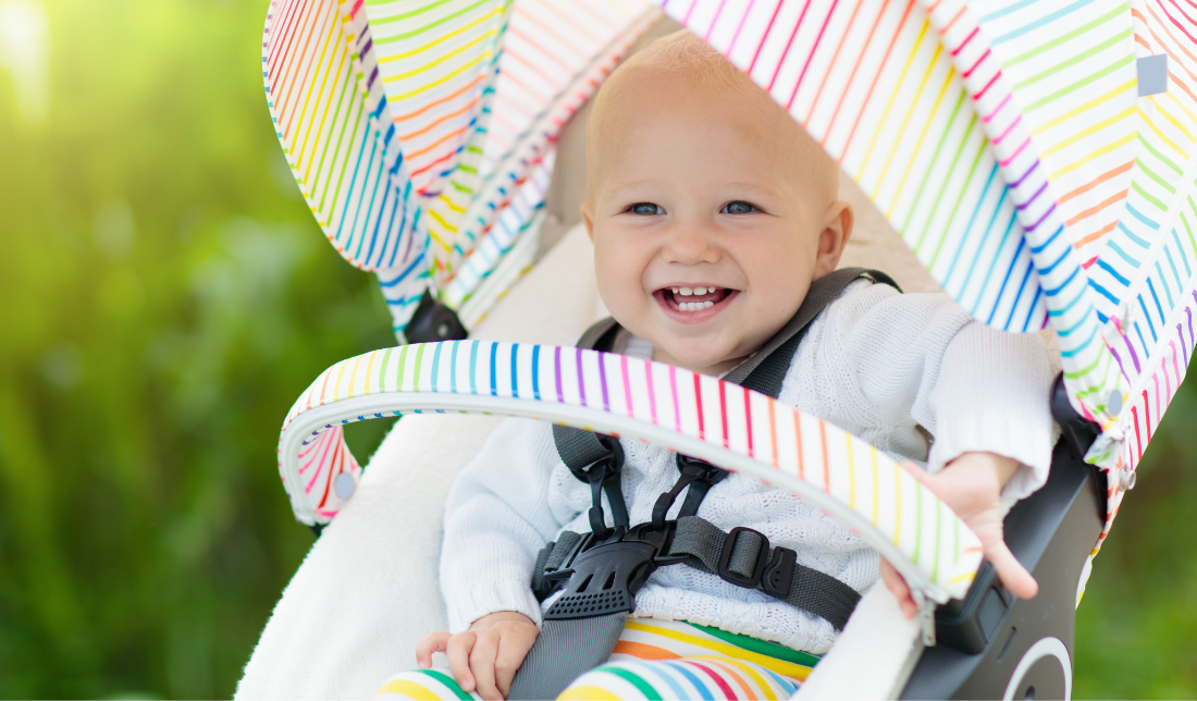 smiling baby wearing safety gear while playing with toys