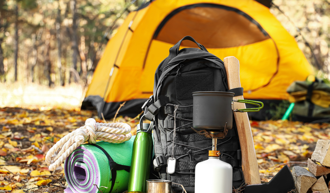tent surrounded by camping gear