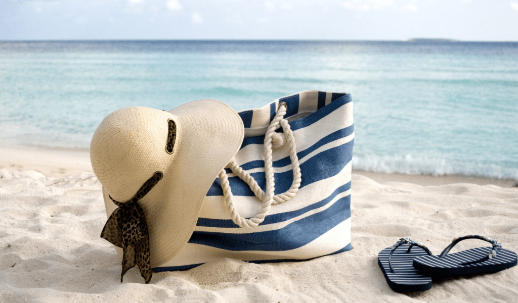 child playing on the beach with a tote bag