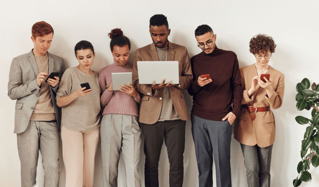 group of people using consumer electronics devices