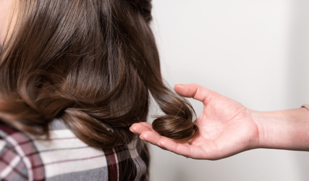 hands holding a lush hair strand