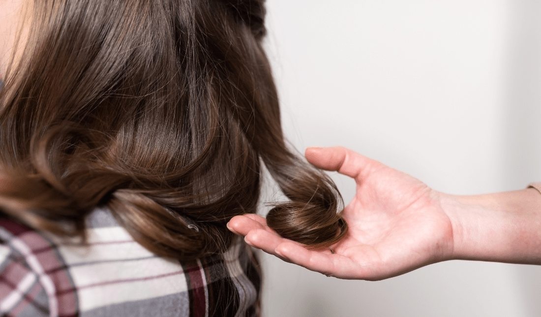 hands holding a lush hair strand