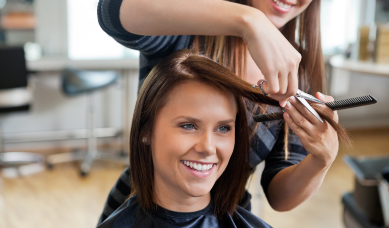 person getting their hair cut in a salon