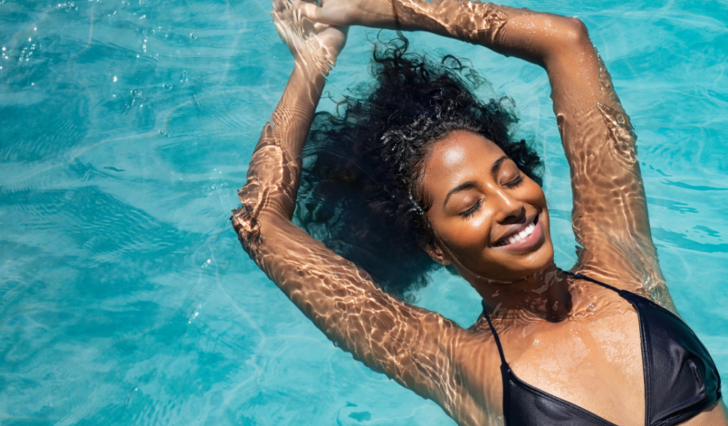 person laying in a tanning bed or swimming pool