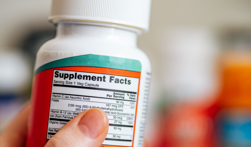 person running through a field with a bottle of nutritional supplements